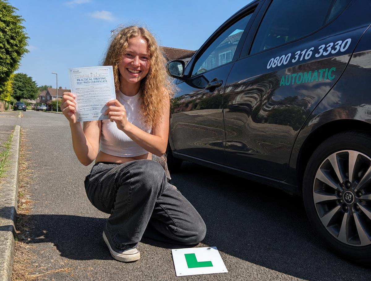 A Pass and Drive learner celebrating with her driving test pass certificate